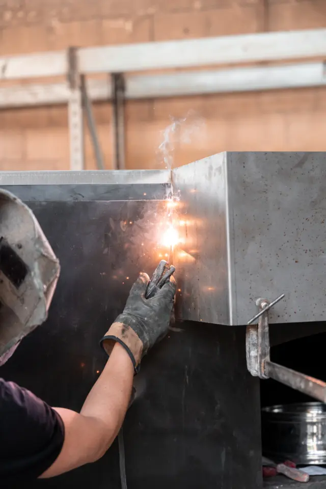 Engineer welding the oven